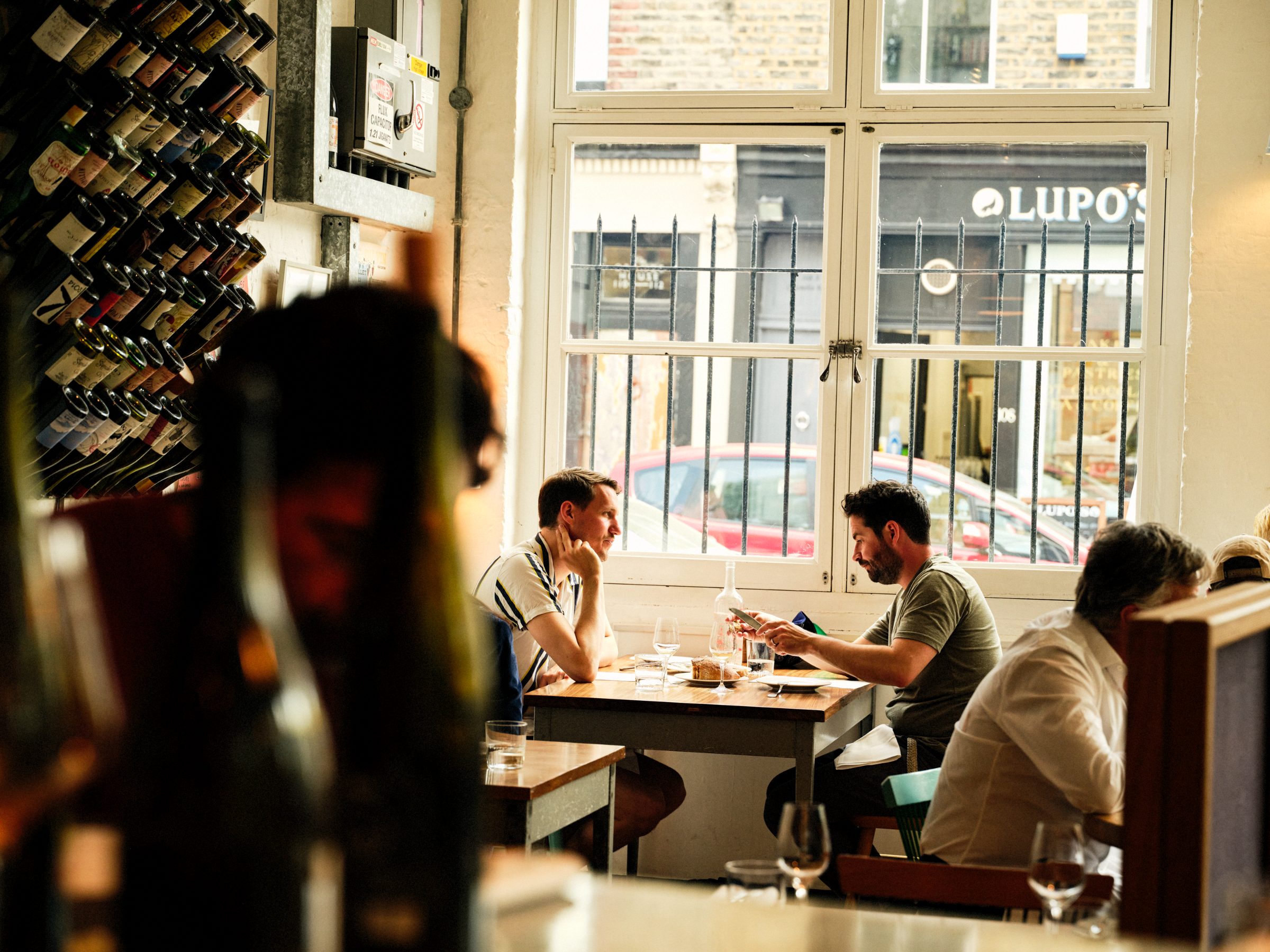 Two people deep in conversation at a window table