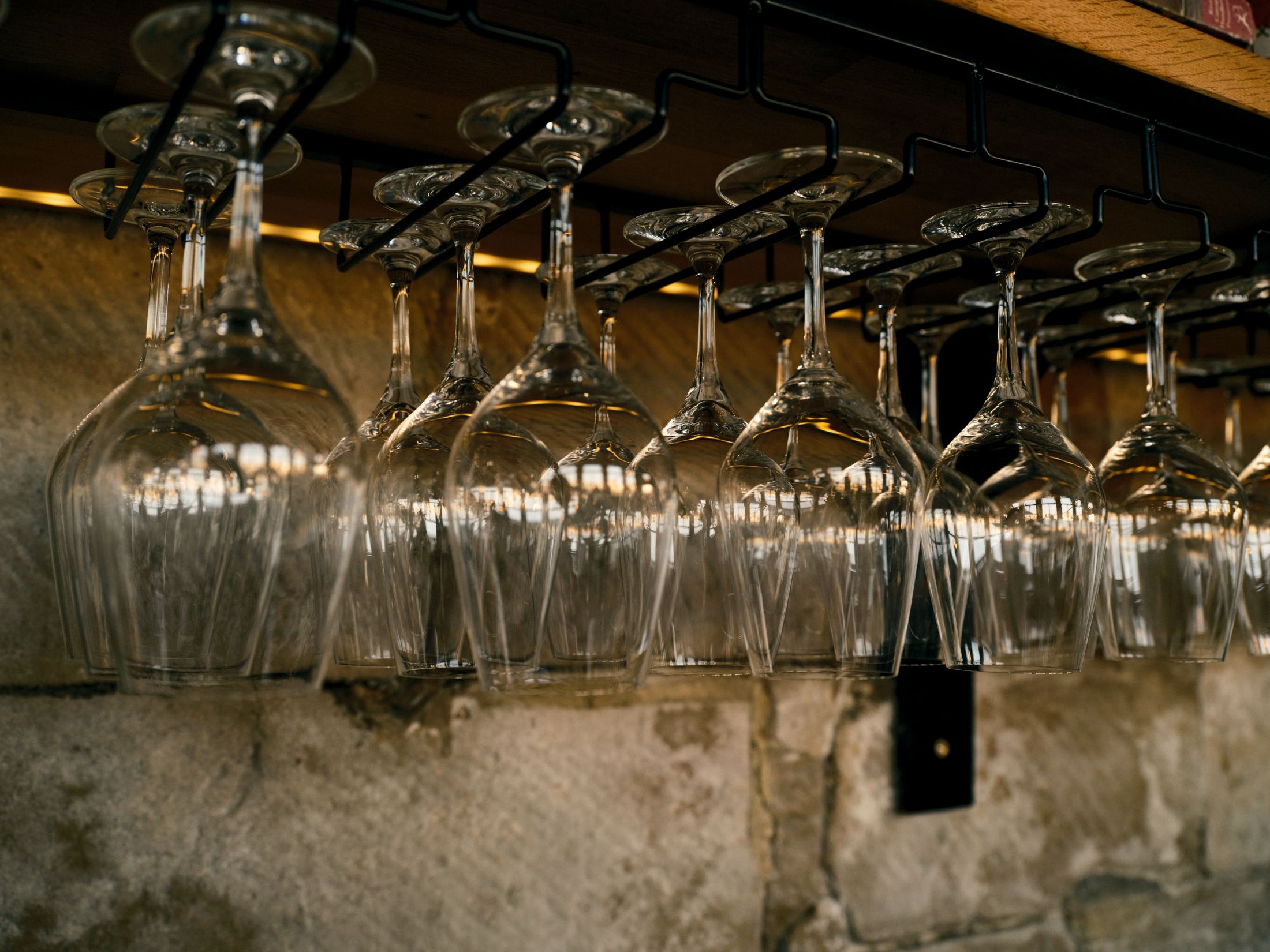 Glasses hanging above a bar